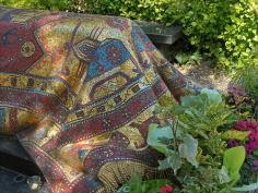 TOMB OF RUDOLF NUREYEV, PARIS ~ DETAIL~ One of the most celebrated ballet dancers of the 20th century, defected from the Soviet Union at age 23, died in 1993 in Paris, buried in the Orthodox Russian cemetery in Sainte-Geneviève-des-Bois near Paris.  His tomb is covered with a mosaic rug designed by artist Ezio Frigerio, made of mosaic tiles of shades of red, blue and gold. It is magnificently draped over his grave.