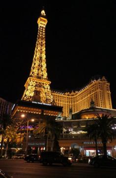 Eiffel Tower Restaurant overlooking the Las Vegas Strip, with the tower above it and the Paris Hotel in the background.