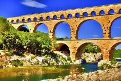 The Pont du Garde is an aqueduct bridge that crosses the Gardon River. You can see the protruding brick used to support the scaffolding.