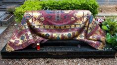 TOMB OF RUDOLF NUREYEV, PARIS ~ One of the most celebrated ballet dancers of the 20th century, defected from the Soviet Union at age 23, died in 1993 in Paris, buried in the Orthodox Russian cemetery in Sainte-Geneviève-des-Bois near Paris.  His tomb is covered with a mosaic rug designed by artist Ezio Frigerio, made of mosaic tiles of shades of red, blue and gold. It is magnificently draped over his grave.