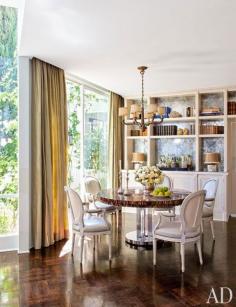 1940s Empire-style bronze chandelier suspended above a horn-inlaid table.