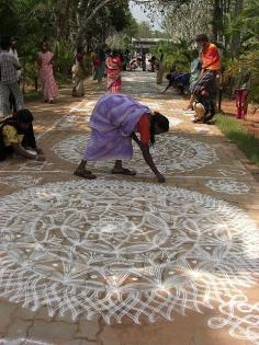 The kolam, or "rangoli" is a traditional mandala, a geometric pattern, that women design in front of their houses during festivities. ..