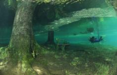 The entire park, benches and all, become submerged under the crystal-clear water from the mountains....