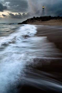 Cape Trafalgar Lighthouse on the shore of the Atlantic Ocean in Spain