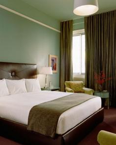 All 177 rooms have high ceilings and a muted color palette, like this Deluxe King room.