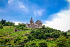 Rüdesheim am Rhein, Rüdesheim am Rhein, Germany - Take a day cruise from Rudesheim to Koblenz for a full day of charming towns, wine vineyards draping the mountains, and ancient castles peaking over the mountain cliffs like this one. BUCKET LIST!  thetradingtravele...