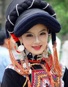 China |  Yi woman.  The Yi costumes vary greatly depending on where they live; in china they live primarily in rural areas of Sichuan, Yunnan, Guizhou and Guangxi, usually in mountainous regions.