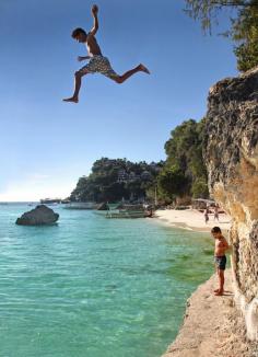 Fearless kids! Cliff Diving from the rocks between White Beach and Diniwid Beach. Boracay, Philippines. 2013 © Sabrina Iovino | JustOneWayTicket.com