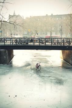 Bicycle on frozen channel, Amsterdam, The Netherlands.