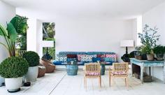 Tour the Ultimate Spanish Vacation Home// Mixed patterns on a patio with woven chairs and a rustic table