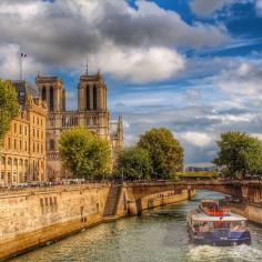 The shadow of Norte Dame looms over the Seine. Photo courtesy of twins_that_travel on Instagram.