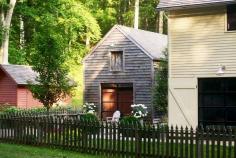 Wooden country farmhouse, surrounded by gorgeous greenery.