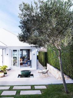 Concrete patio space with rocking chairs and fire pit.