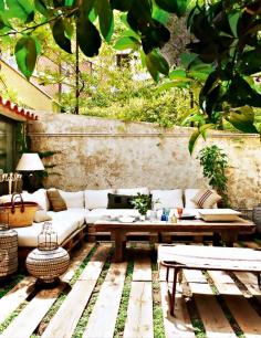 Tour a Feminine, Collected Barcelona Home // Charming Outdoor Space With Palette Seating