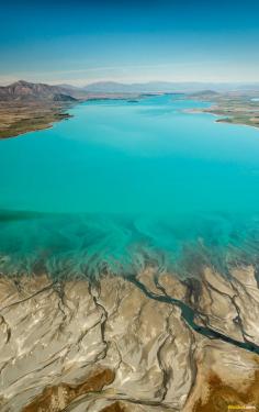 
                        
                            From the air Lake Tekapo appears extra terrestrial in form. A vibrant shade of aquamarine the water looks as though artificially dyed..
                        
                    