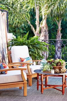 Seating area around a Moroccan tray coffee table with succulents.