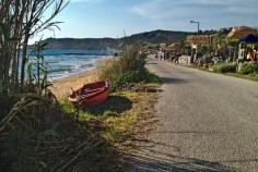 Seafront road along the Mediterranean in the Greek village of Arillas, Corfu, where life is slow and easy and relaxation is the main goal