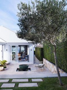 Outdoor space with fire pit and surrounding rocking chairs.