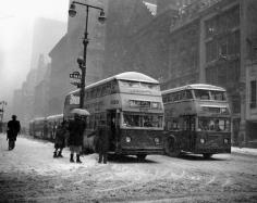 
                    
                        Fifth Avenue is void of its usual crowds of people as shoppers hurry home to get out of a wind-driven snowstorm in 1948. New York City NYC
                    
                