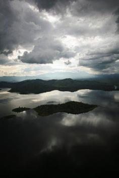 
                    
                        Rwanda. Lake Burera reflects the afternoon sky as a storm rolls in.  Tom Martin
                    
                