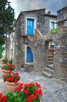 
                    
                        Colletta di Castelbianco | This ancient village is entirely built of stone and is believed to have been established as a defense against the Saracens in the 13th century. Some of the houses have red or blue doors which makes the town ever more charming.
                    
                