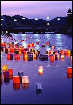 
                    
                        Hiroshima, Japan - Lanterns at Twilight. On the anniversary of the bombing of Hiroshima (August 6th), lanterns are sent floating along the Motoyasu-gawa River.
                    
                