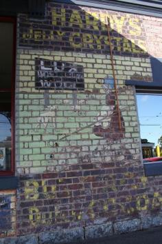 
                    
                        corner of Fenwick and Lygon Streets (187 Fenwick Street). North Carlton Melbourne Australia. These signs reappeared only a few years ago during renovations, according to Carlton Community History Group. The advertisements are for Hardy’s Jelly Crystals, Lux Soap, Butterfly Dutch Cocoa (almost weathered away), Electrine Candles (illustrated with a tall thin white candle) and Velvet Soap. The Lux soap advert is accompanied by a shepherdess...
                    
                