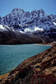 
                    
                        Dragon's Peak looms above Milk Lake in the Himalayas, Gokyo, Nepal.
                    
                