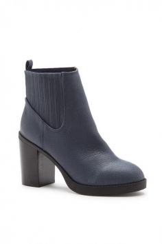 
                    
                        Navy leather booties with elastic goring along the sides
                    
                